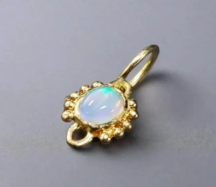 Elegant gold pendant with opal gemstone, perfect for fine jewelry lovers
