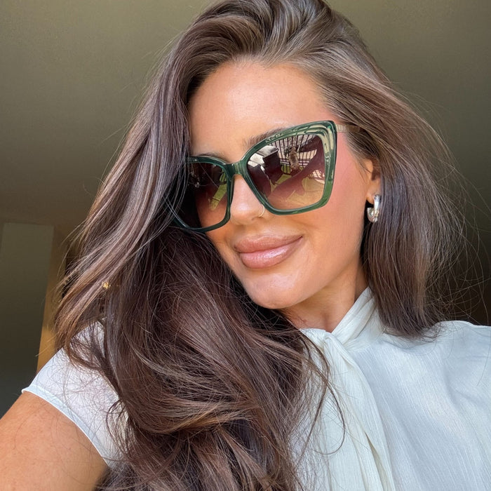 lifestyle - abigail herring wearing oversized deep green cat eye sunglasses 90s hair