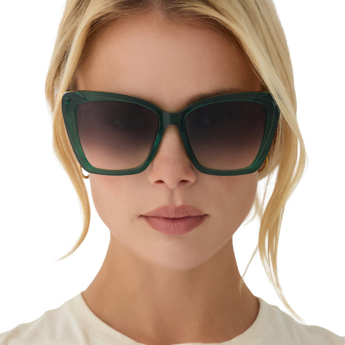 on model - blonde female wearing diff eyewear becky ii oversized cat eye sunglasses with a deep green frame and grey gradient lenses front view