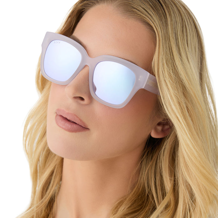 on model - female wearing diff eyewear featuring the bella ii square sunglasses with a thistle light purple frame and lavendar mirror lenses angled view