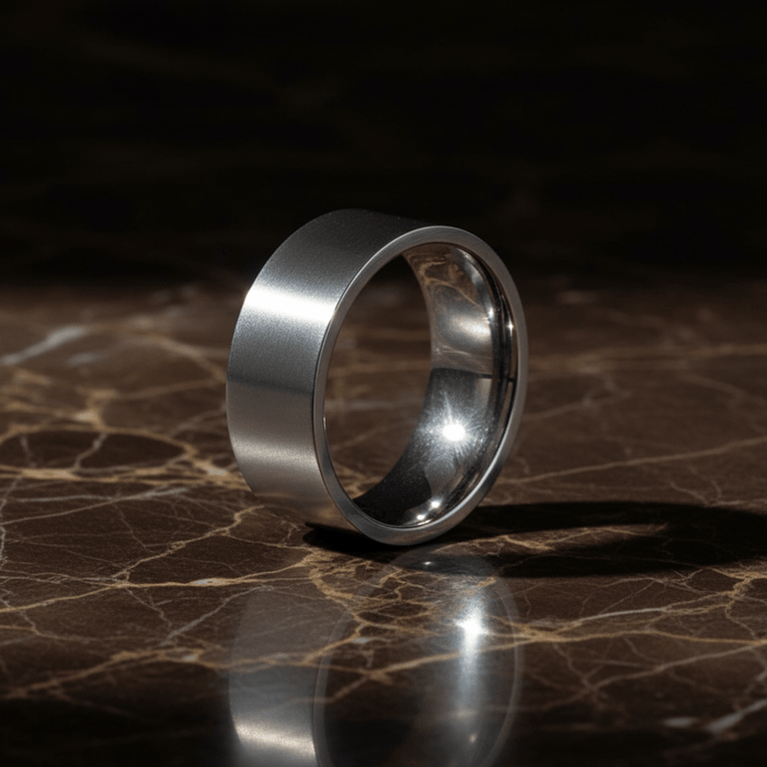 BRAWLER - Luxury 3/4 angle on dark marble - men's tungsten wedding ring.