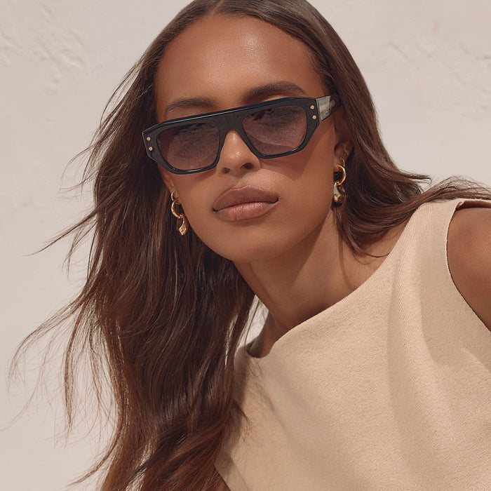 on model - female wearing iconica the calla rectangle sunglasses with a black frame and grey gradient polarized lenses front view