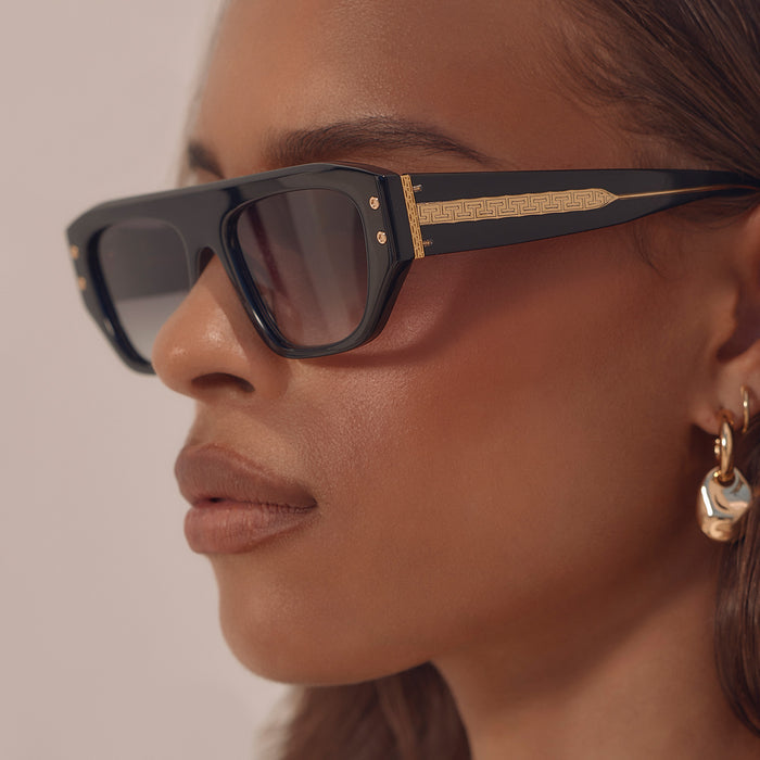 on model - female wearing iconica the calla rectangle sunglasses with a black frame and grey gradient polarized lenses detailed view