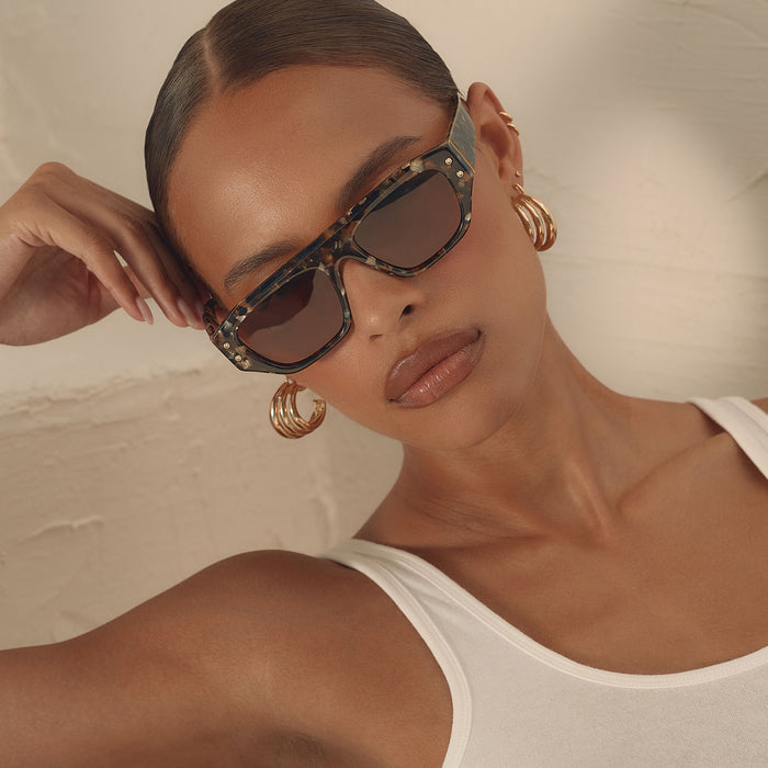 on model - female wearing iconica the calla rectangle sunglasses with a tortoise frame and brown polarized lenses front view