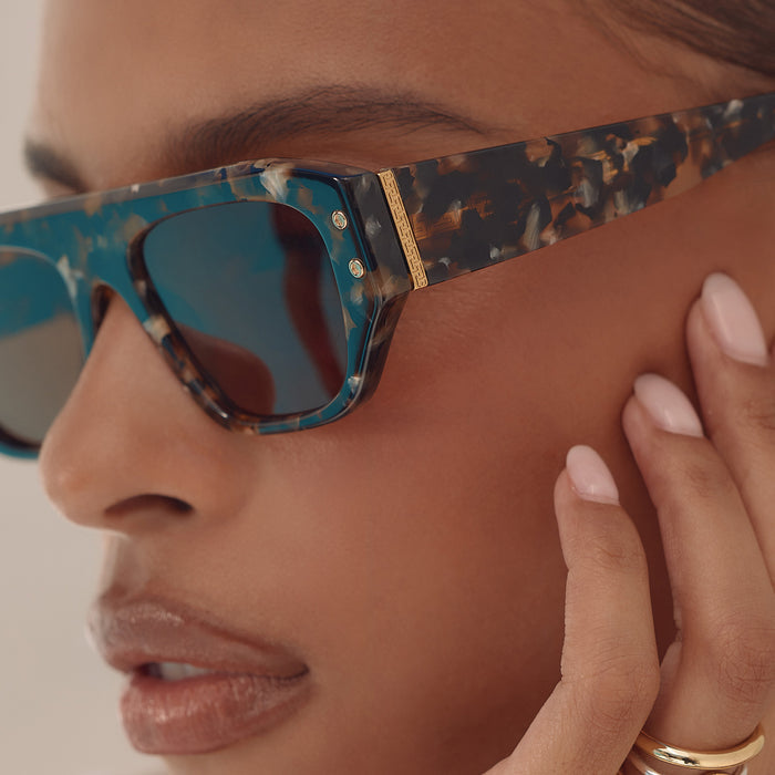 on model - female wearing iconica the calla rectangle sunglasses with a tortoise frame and brown polarized lenses detailed view
