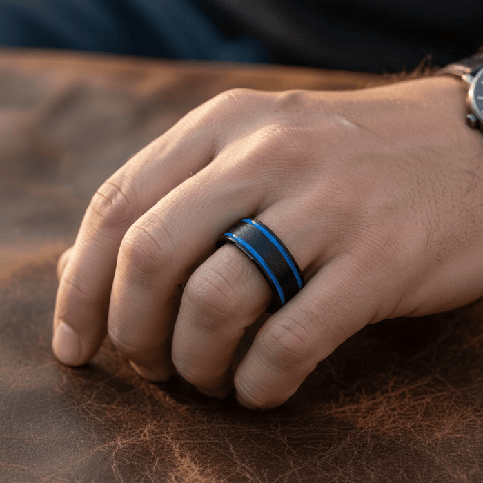 CASTOR — Lifestyle photo on hand — men's tungsten wedding ring.