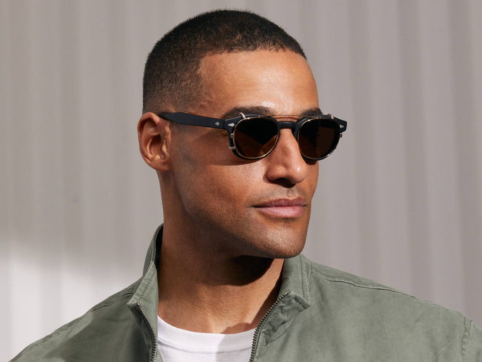 Model is wearing The CLIPTOSH in Gold in size 49 with Gold Mirror Lenses