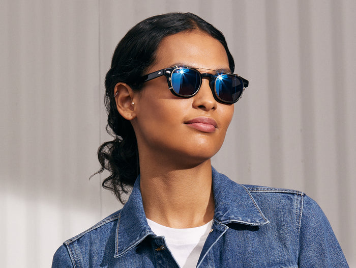 Model is wearing The CLIPTOSH in Gold in size 46 with Blue Mirror Lenses