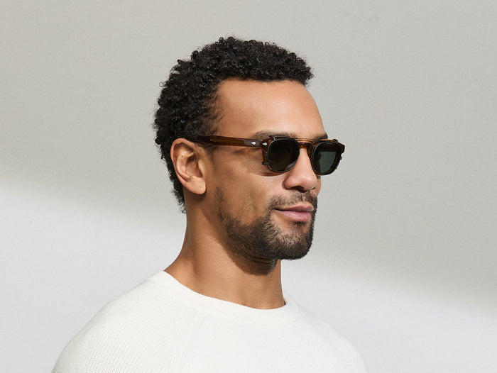 Model is wearing The CLIPTOSH in size 46 in Matte Black with G-15 Polarized Lenses
