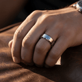 COOPER — Lifestyle photo on hand — men's tungsten wedding ring.