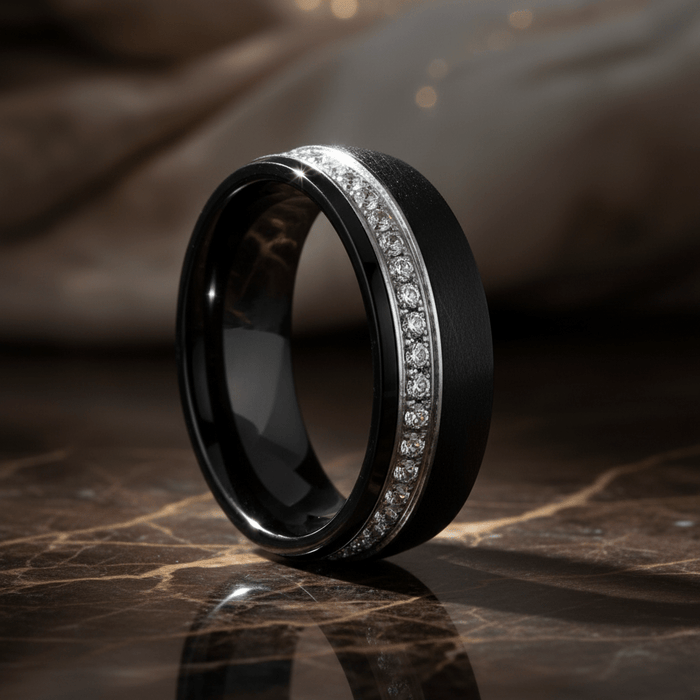 DAZZEL — Luxury 3/4 angle on dark marble — men's tungsten wedding ring.
