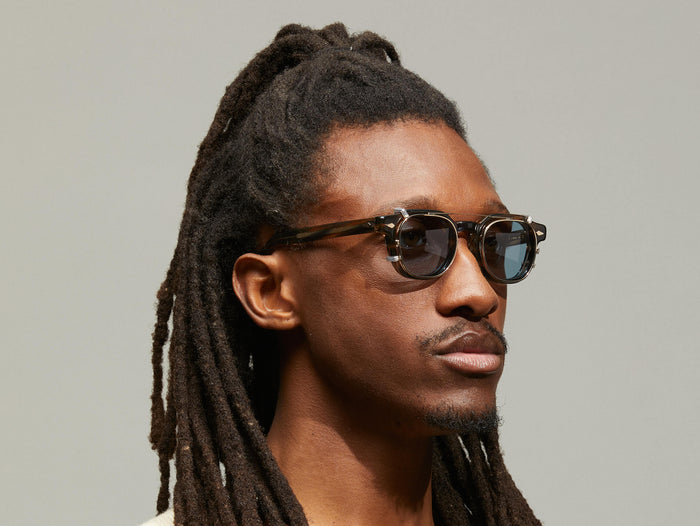 Model is wearing The DOLT CLIP LIMITED EDITION in size 46 in Gold with Blue Tinted Lenses
