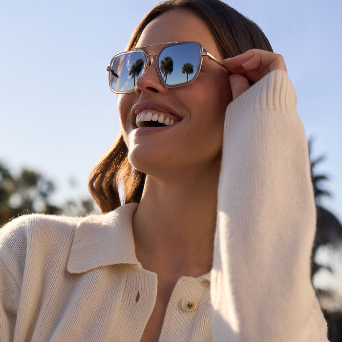 on model - female wearing diff eyewear featuring the jordan navigator sunglasses with a gold frame, clear crystal temple tips and silver mirror lenses front view