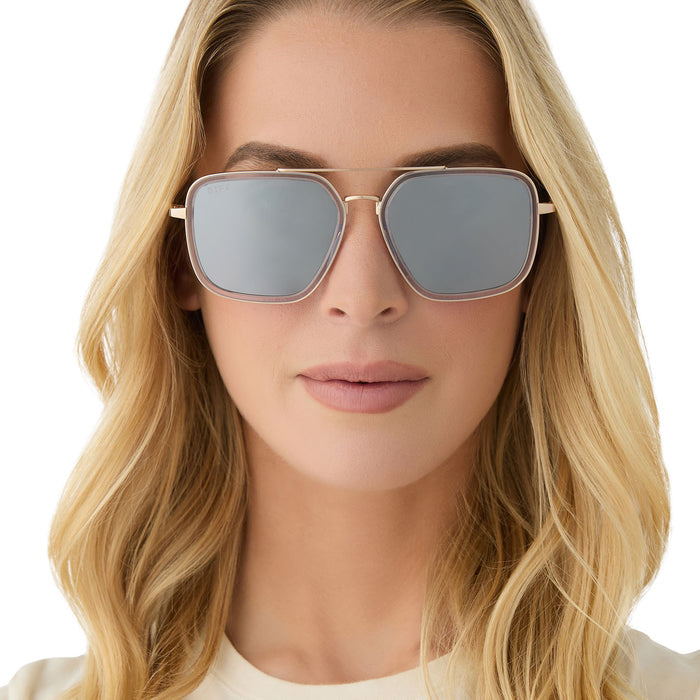on model - female wearing diff eyewear featuring the jordan navigator sunglasses with a gold frame, clear crystal temple tips and silver mirror lenses front view