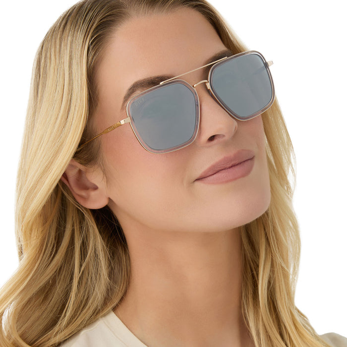on model - female wearing diff eyewear featuring the jordan navigator sunglasses with a gold frame, clear crystal temple tips and silver mirror lenses angled view