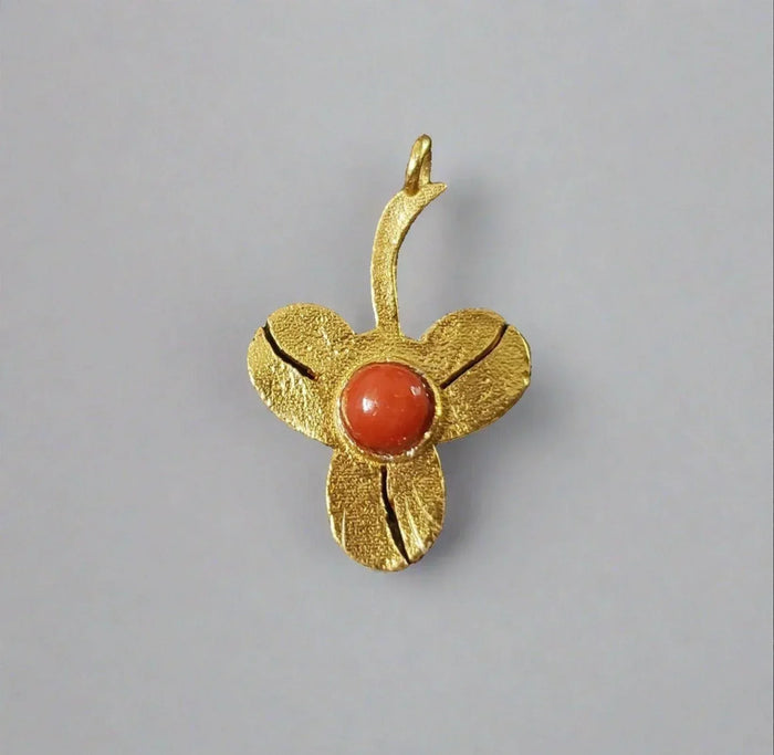 Gold flower pendant with coral center, elegant jewelry accessory