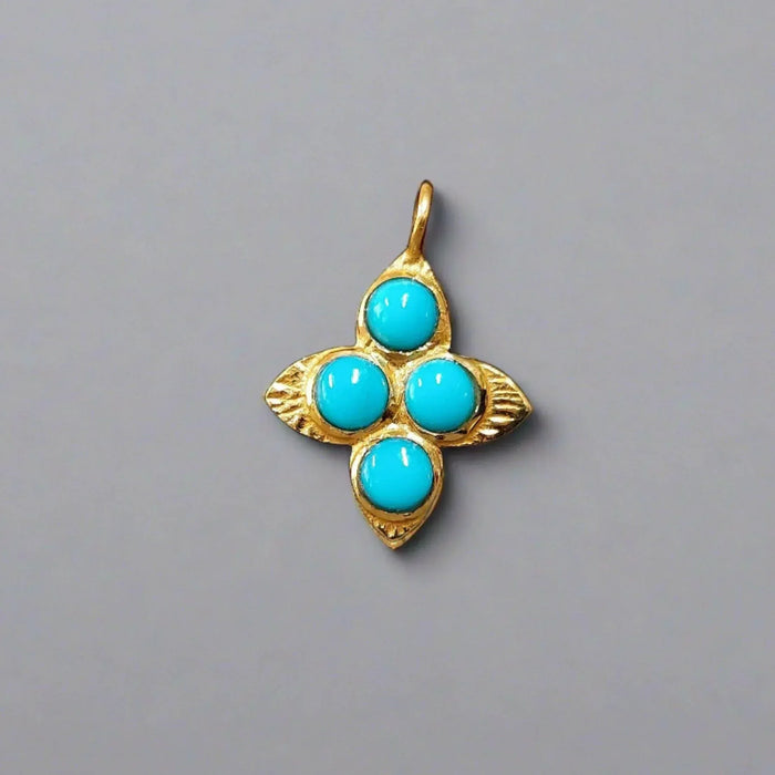 Gold pendant with four turquoise stones in floral design, elegant jewelry accessory