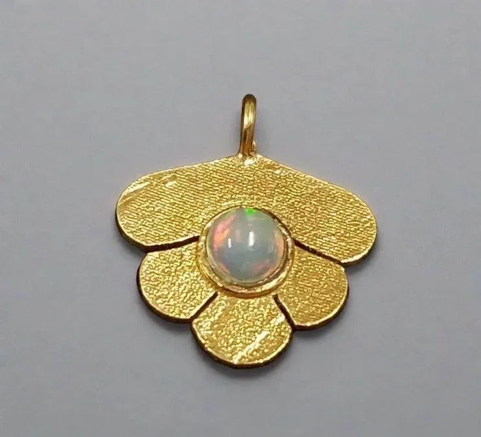 Gold flower pendant with opal center, elegant jewelry accessory