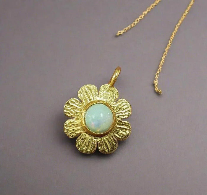 Gold flower pendant with opal center, elegant jewelry accessory