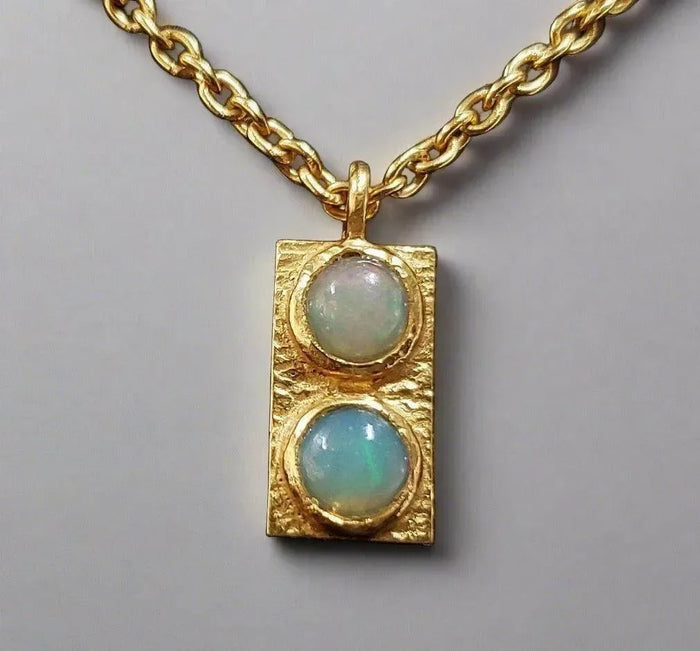 Gold necklace with dual opal pendant, elegant jewelry accessory