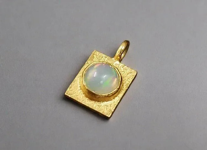 Gold square pendant with opal gemstone, elegant jewelry accessory