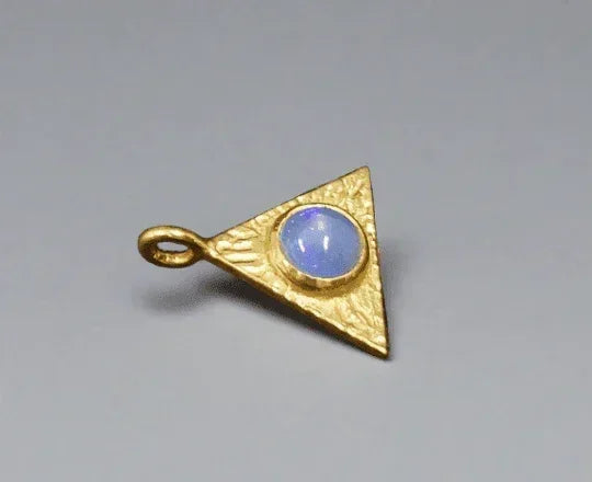 Gold triangle pendant with blue opal gemstone, elegant jewelry accessory