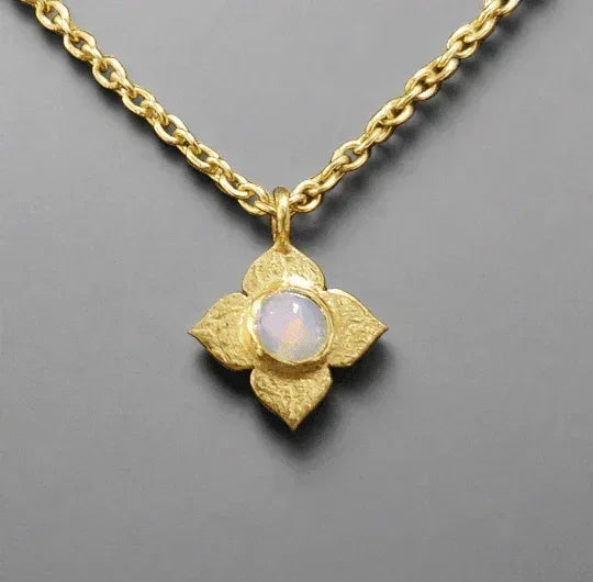 Gold flower pendant necklace with opal center, elegant jewelry accessory