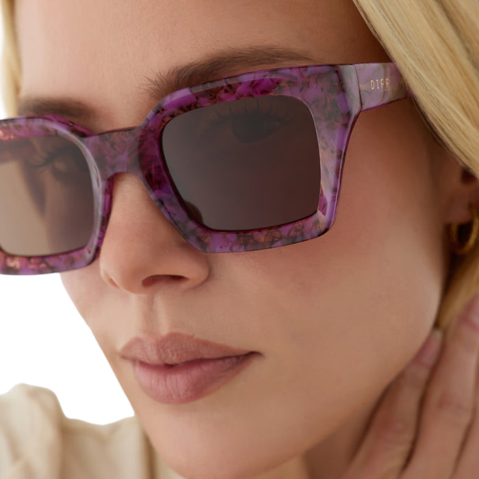 on model - blonde female wearing diff eyewear greer square sunglasses in a lavender haze tortoise acetate frame and brown lenses detailed view