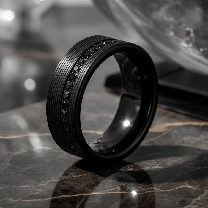 GROOVIX — Luxury 3/4 angle on dark marble — men's tungsten wedding ring.