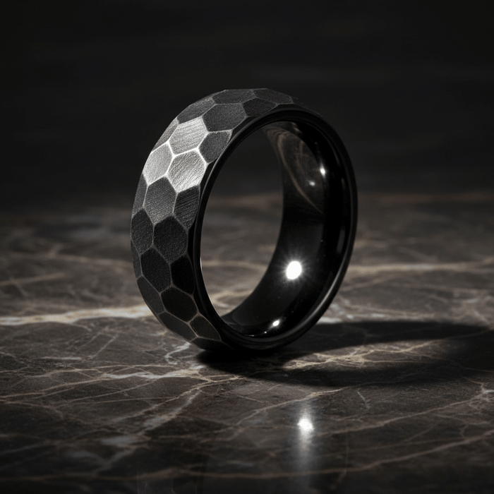 HEXANITE — Luxury 3/4 angle on dark marble — men's tungsten wedding ring.