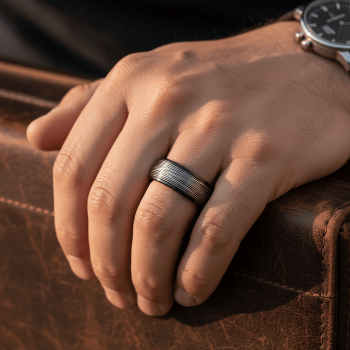 HURRICANE — Lifestyle photo on hand — men's tungsten wedding ring.