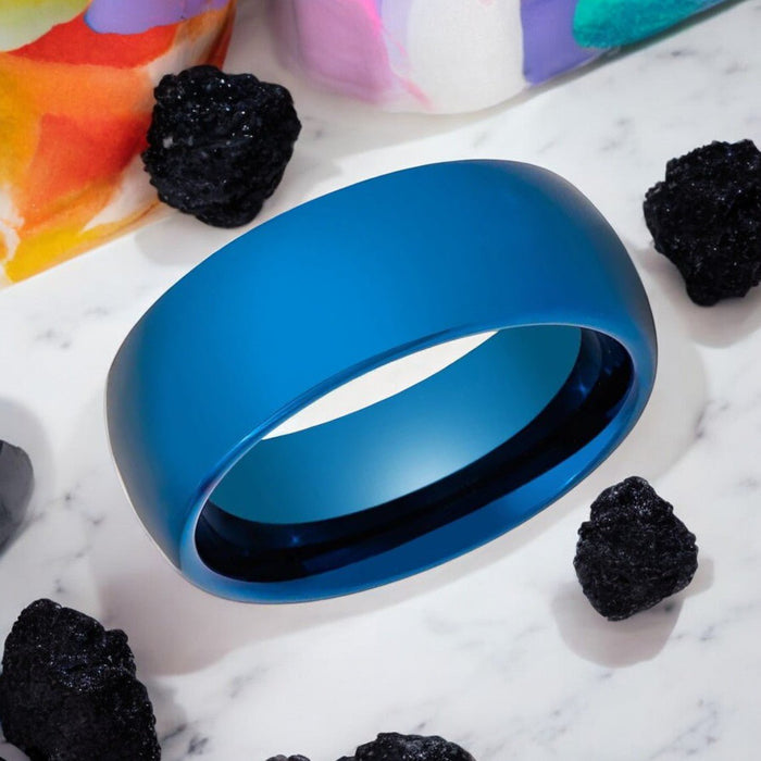 Angled display of polished electric blue tungsten band