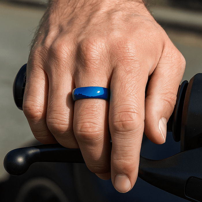 Close-up of domed surface on blue tungsten ring on middle finger hand