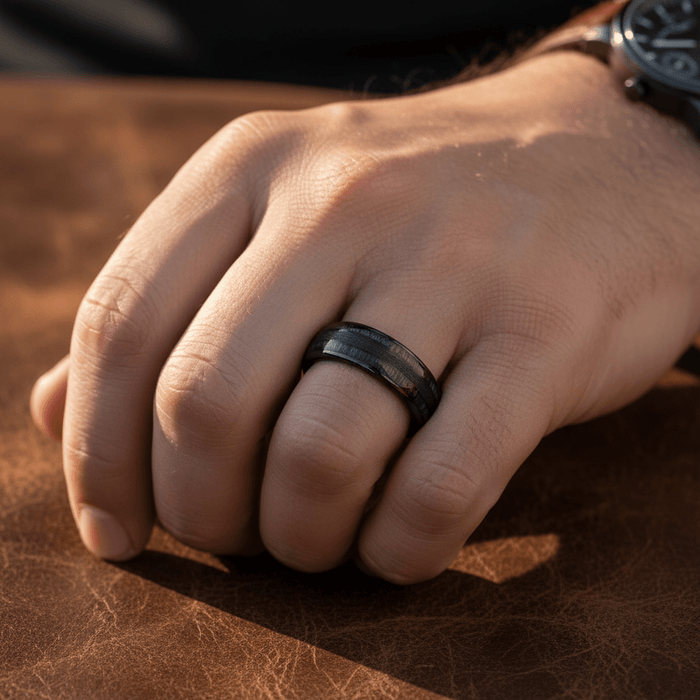 LUQUE — Lifestyle photo on hand — men's tungsten wedding ring.