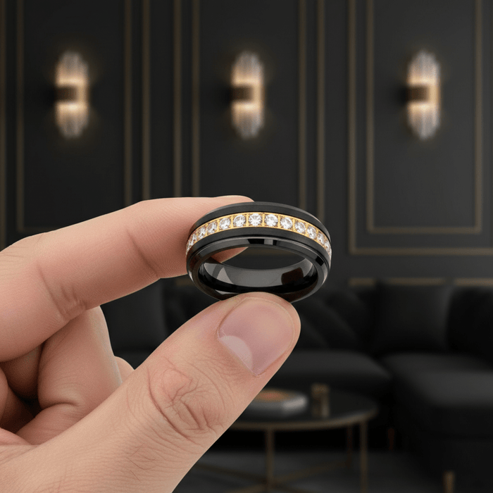 LUSTRE — Held between fingers close-up — men's tungsten wedding ring.