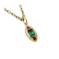 Elegant gold pendant necklace with emerald and ruby gemstones, showcasing luxury jewelry design
