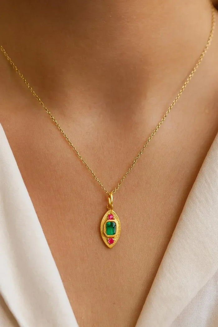 Gold necklace with emerald and ruby pendant, elegant jewelry accessory for women