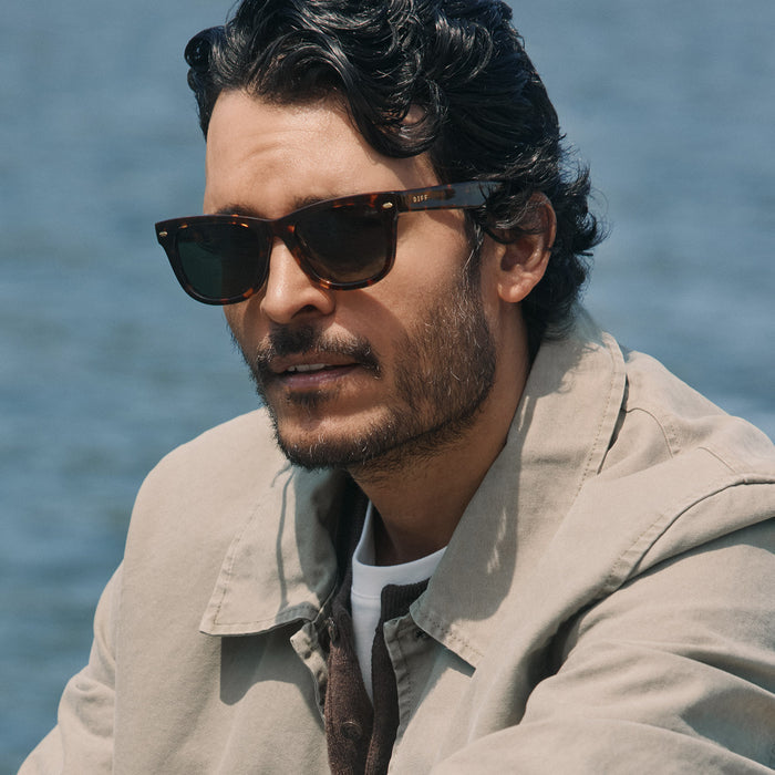 lifestyle - male wearing diff eyewear mercer square sunglasses with a rich tortoise acetate frame and g15 polarized lenses angled view