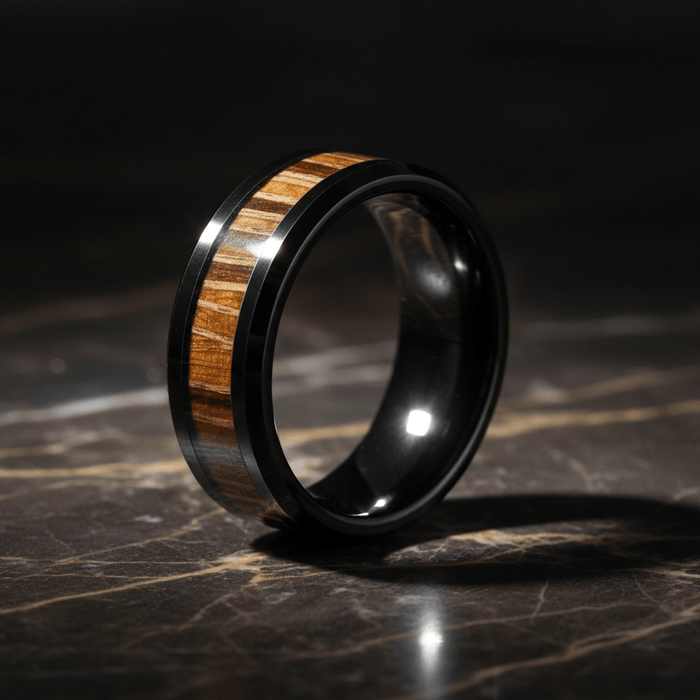 MESA — Luxury 3/4 angle on dark marble — men's tungsten wedding ring.