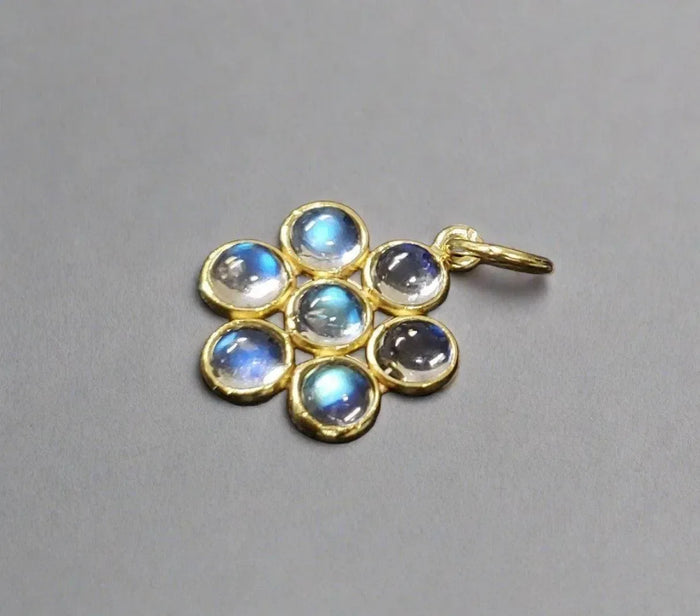Gold pendant with seven iridescent moonstones, elegant jewelry accessory