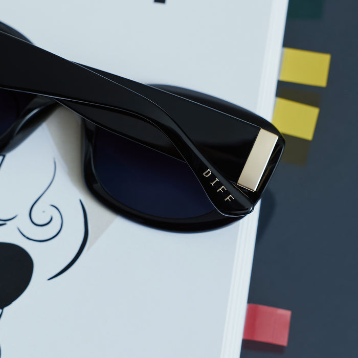 still life - the devil wears prada x diff eyewear mirana glasses resting on a play bill