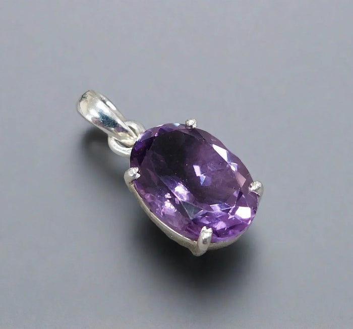 Elegant amethyst pendant in silver setting, featuring a faceted purple gemstone for sophisticated jewelry lovers.