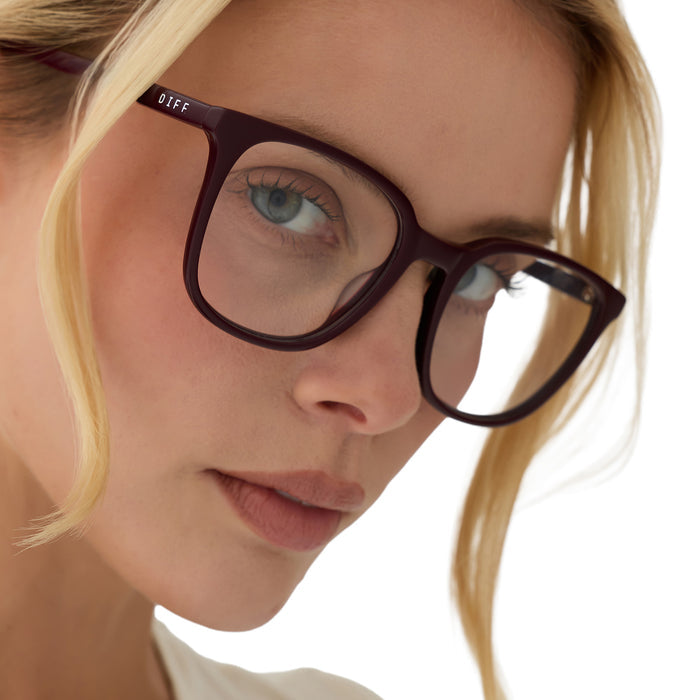 on model - blonde female wearing diff eyewear parker square prescription glasses with a dark cherry lacquer red acetate frame angled view