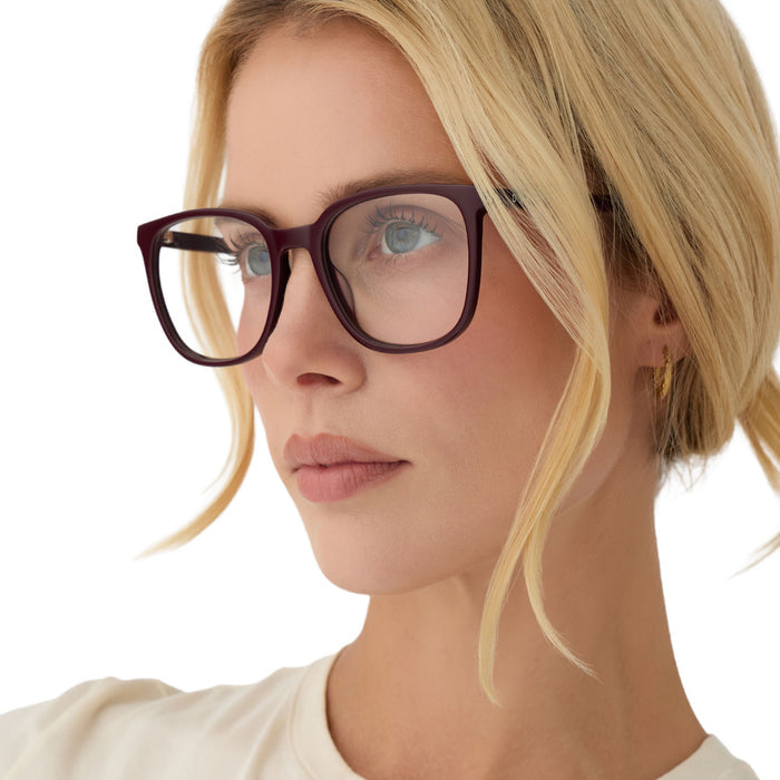 on model - blonde female wearing diff eyewear parker square prescription glasses with a dark cherry lacquer red acetate frame angled view