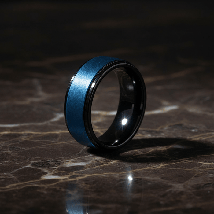ROCKET — Luxury 3/4 angle on dark marble — men's tungsten wedding ring.