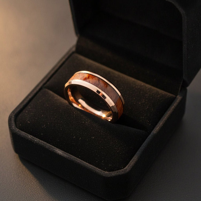 RUSTIC rose gold plated tungsten carbide wedding band with hawaiian koa wood inlay running around the band and shiny polished beveled edges nested in a black velvet ring box, editorial jewelry shot