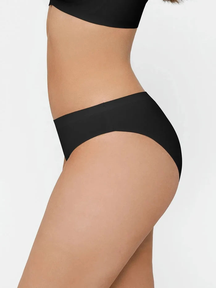 Seamless high-stretch bikini in black, showing hip and thigh.