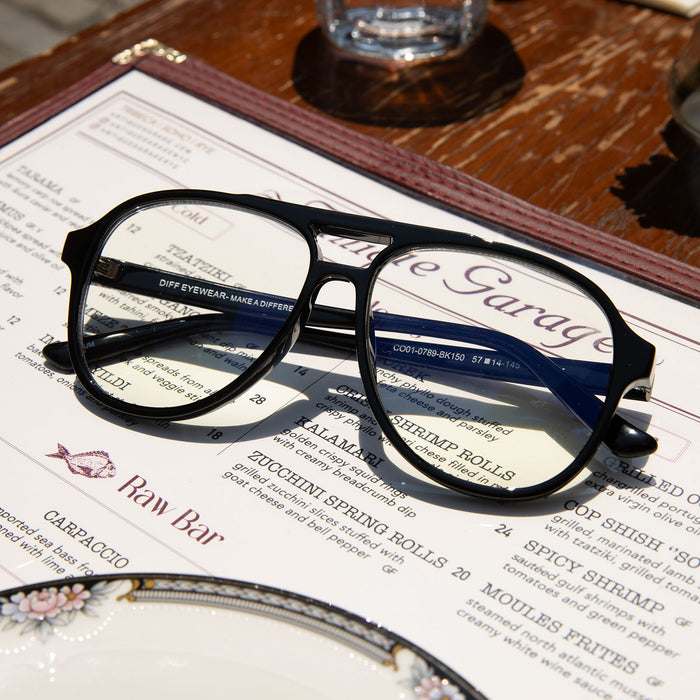 still life of tatum black prescription glasses laying on a menu