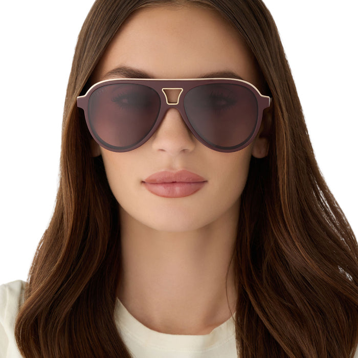 on model - female wearing diff eyewear featuring the tosca iii aviator sunglasses with a rugby red acetate and gold accent frame and burgundy gradient polarized lenses front view