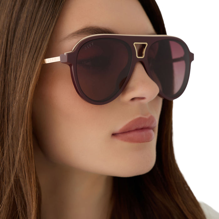 on model - female wearing diff eyewear featuring the tosca iii aviator sunglasses with a rugby red acetate and gold accent frame and burgundy gradient polarized lenses angled view